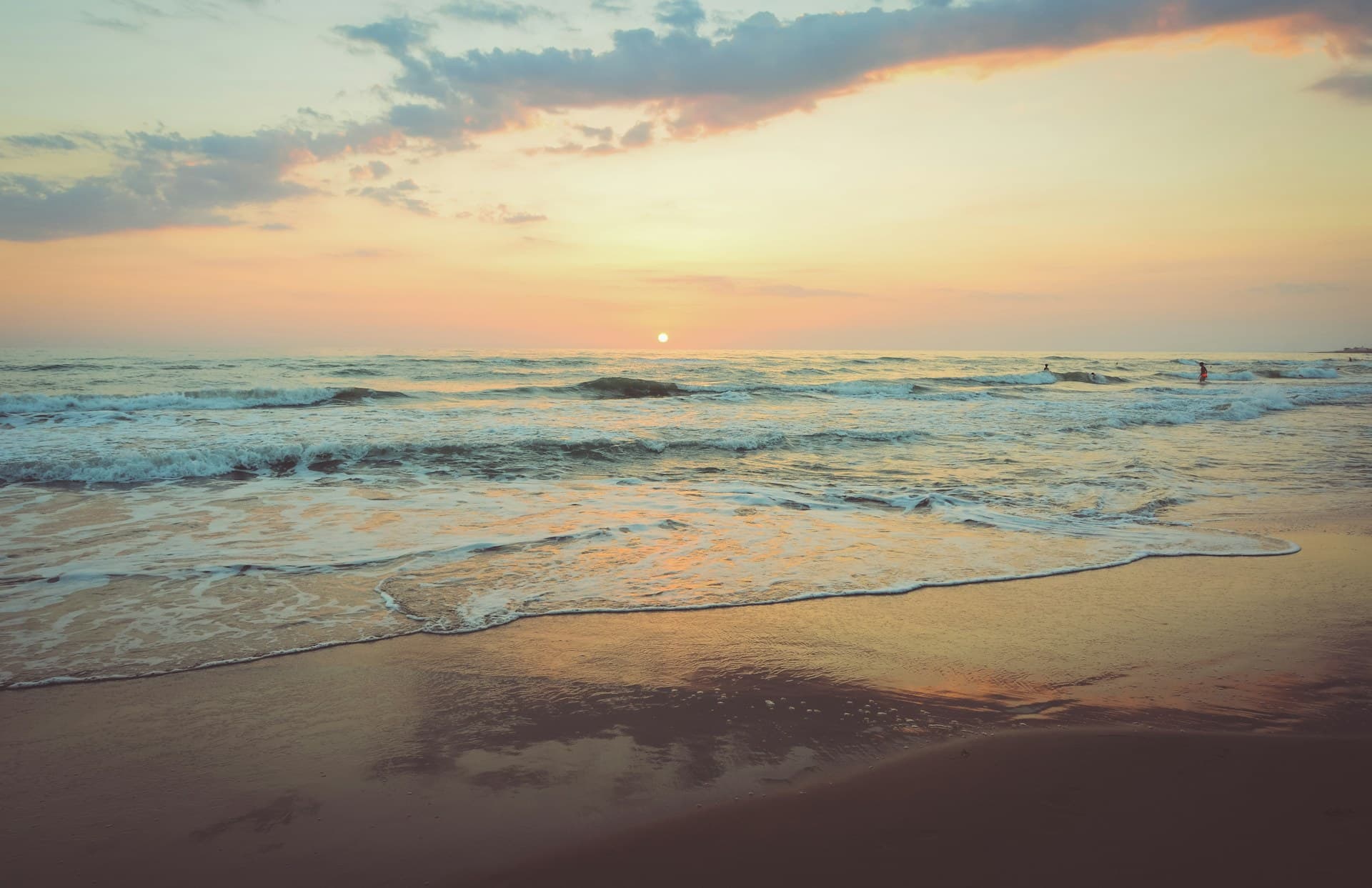A calm Gulf beach with smooth paved boardwalk access at Naples