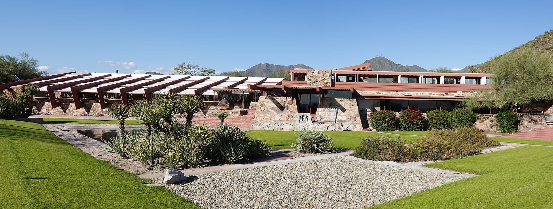 A smooth paved path through a desert botanical garden