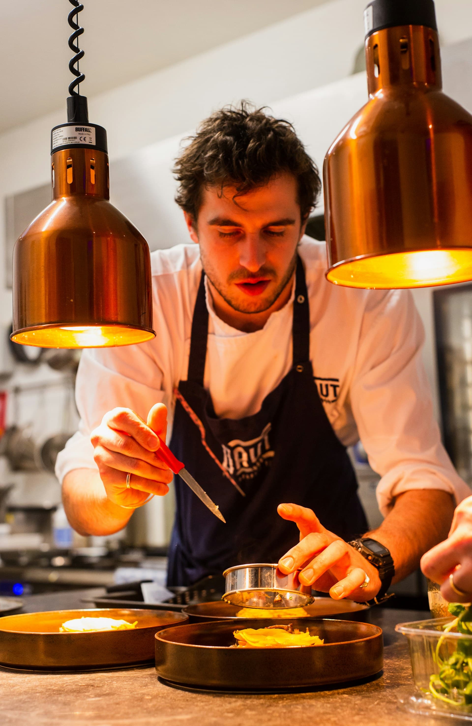 A chef plating a seasonal tasting course at a fine Aspen restaurant