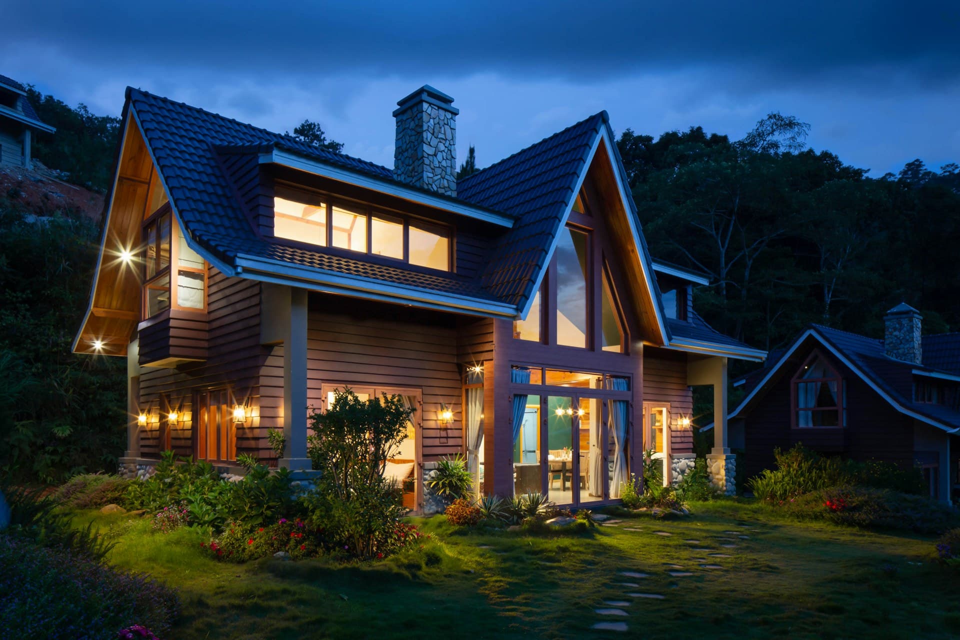 A group gathered at a mountain residence terrace above Snowmass at dusk