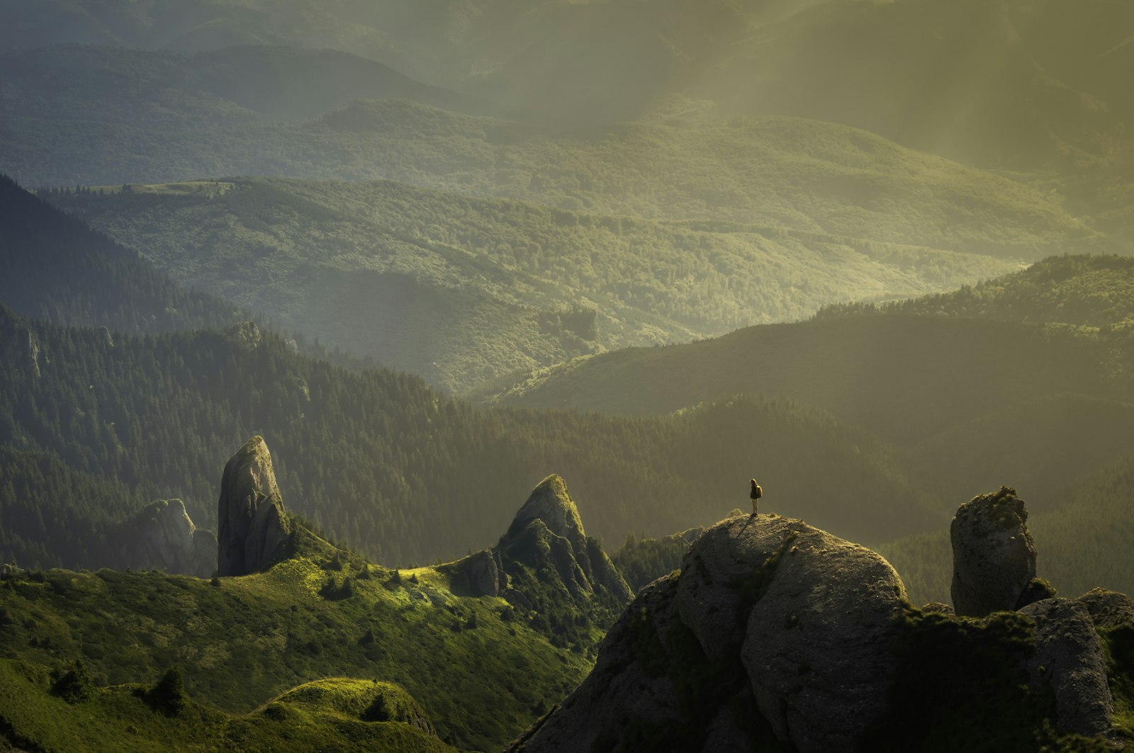 Mountain peaks glowing in golden light above an alpine valley